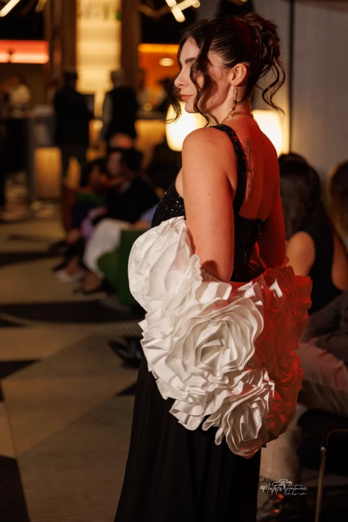 Femme de profil, en robe de soirée avec un châle blanc avec un maquillage élégant.